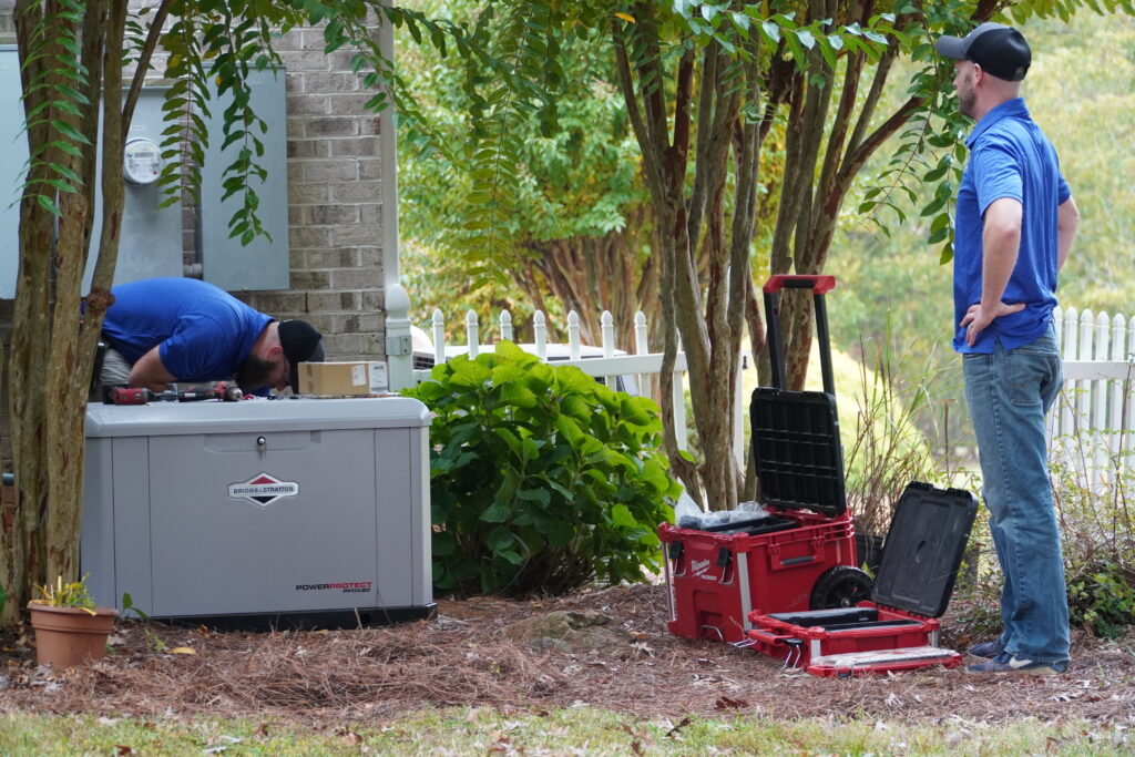 Two Chamberlain electricians working on a generator