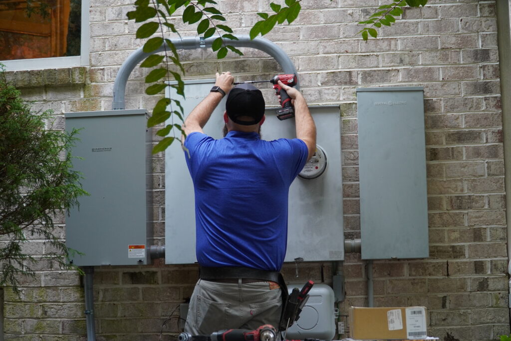 Chamberlain electrician working on a power panel